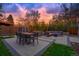 Outdoor patio features elegant pavers, lounge furniture, string lights, and a manicured lawn at 1645 Wabash St, Denver, CO 80220