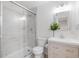 Modern bathroom features a marble-tiled shower, toilet, and a stylish vanity with ample storage at 1645 Wabash St, Denver, CO 80220