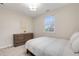 Bright bedroom features natural light, a full bed, and a dresser for ample storage at 1645 Wabash St, Denver, CO 80220