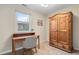 Bedroom with a dedicated study area, natural light, and a rustic wooden wardrobe for storage at 1645 Wabash St, Denver, CO 80220
