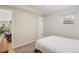 Bedroom featuring neutral colors, a comfortable bed, and a view into the closet at 1645 Wabash St, Denver, CO 80220