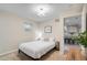 Bedroom featuring a comfortable bed, neutral colors, and a view into the modern kitchen at 1645 Wabash St, Denver, CO 80220