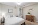 Cozy bedroom features neutral walls, carpeted floors, a queen bed and dresser for ample storage at 1645 Wabash St, Denver, CO 80220