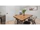 Dining area with a rustic wooden table, seating for four, and neutral decor at 1645 Wabash St, Denver, CO 80220