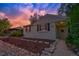 Charming home with well-maintained front yard and unique landscaping under a beautiful sky at 1645 Wabash St, Denver, CO 80220
