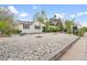 Inviting home with stone landscaping, metal planters, and healthy small trees at 1645 Wabash St, Denver, CO 80220
