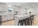 Open kitchen featuring a large island with seating, stainless steel appliances, and modern cabinetry at 1645 Wabash St, Denver, CO 80220