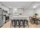 Bright kitchen features white cabinets, stainless steel appliances, and center island with bar seating at 1645 Wabash St, Denver, CO 80220