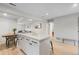 Open kitchen and dining area with modern finishes, light wood floors, and stainless steel appliances at 1645 Wabash St, Denver, CO 80220