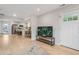Open-concept living area with wood floors, modern TV stand, and seamless flow to kitchen at 1645 Wabash St, Denver, CO 80220