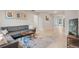 Cozy living room featuring a comfortable gray couch, colorful rug, and ample natural light at 1645 Wabash St, Denver, CO 80220