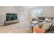 Cozy living room featuring a comfortable gray couch, colorful rug, and a TV with streaming content at 1645 Wabash St, Denver, CO 80220