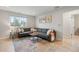 Comfortable living room with a large sectional sofa, patterned rug, and bright natural light at 1645 Wabash St, Denver, CO 80220