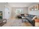 Bright living room featuring a gray sofa, stylish rug, and plenty of natural light at 1645 Wabash St, Denver, CO 80220