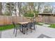 Backyard dining set with patio in a manicured lawn with surrounding trees at 1645 Wabash St, Denver, CO 80220