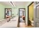 Bathroom with double sinks, modern fixtures, and views into the connected bedrooms at 1727 N Pearl St # 107, Denver, CO 80203