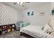 Charming bedroom featuring a cozy chair, comfortable bed, and playful decor at 1727 N Pearl St # 107, Denver, CO 80203