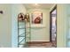Hallway with stylish wine rack and decor leads to other rooms in this well-maintained condo at 1727 N Pearl St # 107, Denver, CO 80203