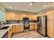 Spacious kitchen with stainless steel appliances, light wood cabinets, and quartz countertops at 1727 N Pearl St # 107, Denver, CO 80203