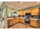 Well-lit kitchen featuring stainless steel appliances, quartz countertops, and wood-look flooring at 1727 N Pearl St # 107, Denver, CO 80203