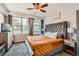 Bedroom featuring a large bed, ample natural light, and city views at 1727 N Pearl St # 107, Denver, CO 80203