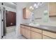 Traditional bathroom with light wood cabinetry and a combined shower and tub at 7232 S Costilla St, Littleton, CO 80120