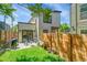 Private backyard includes a patio, green grass, a grill, and a wood fence at 2143 S Acoma St, Denver, CO 80223