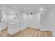 Finished basement area with laminate flooring, a kitchenette, and a white door at 2143 S Acoma St, Denver, CO 80223