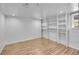 Finished basement area with laminate flooring, white walls, and storage shelves at 2143 S Acoma St, Denver, CO 80223