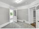 Bedroom featuring carpeting, neutral paint, and access to multiple rooms via white doors at 2143 S Acoma St, Denver, CO 80223