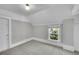 Bedroom featuring neutral paint, carpeting, a window, and a white door and baseboard at 2143 S Acoma St, Denver, CO 80223