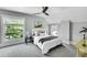 Cozy bedroom with natural light, fan, and a comfortable bed at 2143 S Acoma St, Denver, CO 80223