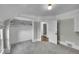 Bedroom featuring carpeting, neutral paint, access to a closet, and a door that leads to another room at 2143 S Acoma St, Denver, CO 80223