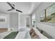 Bright bedroom featuring a ceiling fan, neutral paint, and a comfortable bed with decorative pillows at 2143 S Acoma St, Denver, CO 80223