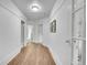 Hallway featuring hardwood floors and bright, white walls at 2143 S Acoma St, Denver, CO 80223