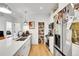 Modern kitchen boasts white cabinets, stainless steel appliances, and a pantry at 2143 S Acoma St, Denver, CO 80223