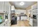 Bright kitchen featuring stainless steel appliances, stylish backsplash, and hardwood floors at 2143 S Acoma St, Denver, CO 80223