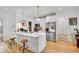 Stylish kitchen with white cabinets, a center island with seating, and stainless steel appliances at 2143 S Acoma St, Denver, CO 80223