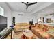 Cozy living room with comfortable seating, a ceiling fan, and a view into the kitchen at 2143 S Acoma St, Denver, CO 80223