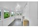 Bright sunroom with multiple windows and a hardwood floor at 2143 S Acoma St, Denver, CO 80223