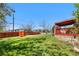 Well-maintained backyard featuring healthy grass, privacy fence, covered patio, and established trees at 2698 Fern Dr, Westminster, CO 80030