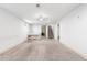 Spacious carpeted basement with drop ceiling, piano, and staircase leading to the upper level at 2698 Fern Dr, Westminster, CO 80030