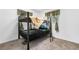 This bedroom includes a black metal framed bunk bed with gray carpeting and natural light from the window at 2698 Fern Dr, Westminster, CO 80030