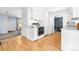 Bright kitchen with ample cabinetry, laminate floors, and open layout to other rooms at 2698 Fern Dr, Westminster, CO 80030
