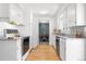 Well-lit kitchen with classic white cabinets and a seamless transition into the dining area at 2698 Fern Dr, Westminster, CO 80030