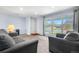 Cozy living room with natural light, plush seating, and a view of the front yard at 2698 Fern Dr, Westminster, CO 80030