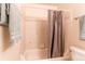 Bathroom view showcases tiled shower and tub combo with neutral curtain and towel at 8228 Marshall Ct, Arvada, CO 80003