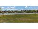 Picturesque community view featuring a tranquil lake surrounded by lush greenery and residential homes at 8228 Marshall Ct, Arvada, CO 80003