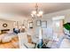 Elegant dining room with glass table and chairs open to living room and kitchen at 8228 Marshall Ct, Arvada, CO 80003