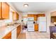 Bright kitchen featuring ample cabinetry, stainless steel sink, and view of the dining area at 8228 Marshall Ct, Arvada, CO 80003